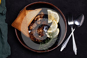 Chicken Steak with Black Pepper Garnish with Lemon and Rosemary. Dark Tone