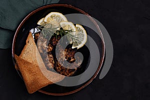 Chicken Steak with Black Pepper Garnish with Lemon and Rosemary. Dark Tone