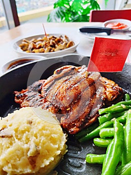 Chicken steak with mashed potato and vegetables