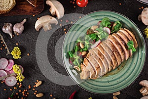 Chicken steak roasted and salad, food photography. Black background. Top view