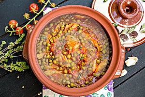 Chicken stew with peas and tomatoes photo