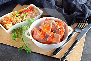 Chicken stew with pineapple and chili tomato sauce in a white bowl