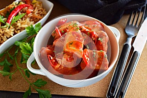 Chicken stew with pineapple and chili tomato sauce in a white bowl