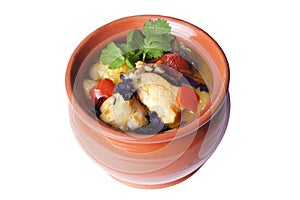 Chicken stew with potatoes and vegetables in a clay pot