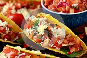 Chicken tacos with salsa, cheese and corn tortila