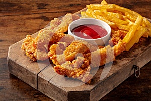 Chicken tenders, breaded nuggets, with a bbq dip and French fries