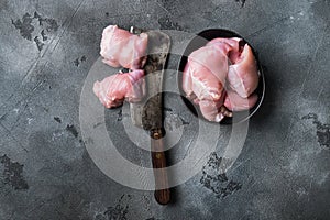 Chicken thighs on grey backgroundtop viewwith space for text