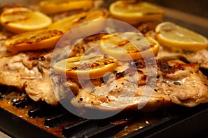 Chicken thighs on the Grill topped with lemons