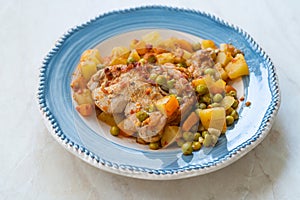Chicken Thighs with Potato, Carrot and Green Peas served in Plate for One Portion photo