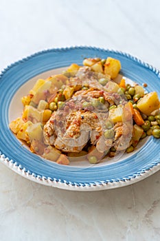 Chicken Thighs with Potato, Carrot and Green Peas served in Plate for One Portion photo