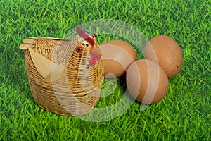 A chicken with three brown eggs