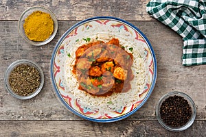 Chicken tikka masala with basmati rice on wood