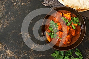 Chicken Tikka masala in the bowl. Asian food. Top view, copy space.