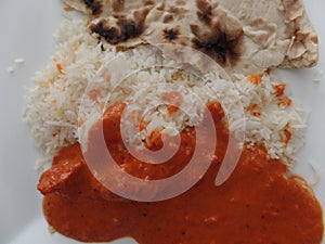 Chicken tikka masala curry with pilau rice and roti