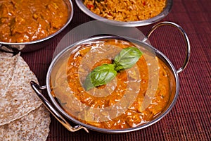 Chicken Tikka Masala Curry on Rattan Background