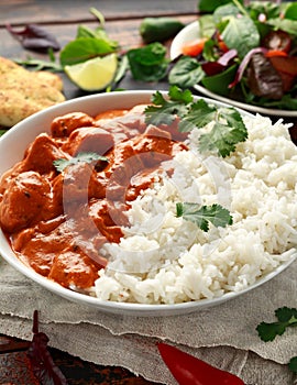 Chicken tikka masala curry with rice and naan bread