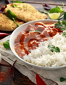 Chicken tikka masala curry with rice and naan bread