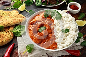 Chicken tikka masala curry with rice and naan bread