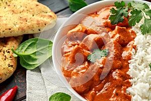 Chicken tikka masala curry with rice and naan bread. close up