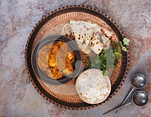 Chicken tikka masala with pulao rice and naan bread photo