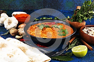 Chicken tikka masala spicy curry meat food in pot with rice and naan bread. indian food