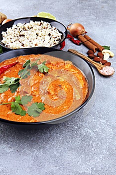 Chicken tikka masala spicy curry meat food in pot with rice and naan bread. indian food