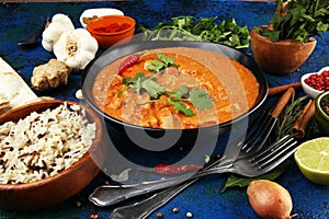 Chicken tikka masala spicy curry meat food in pot with rice and naan bread. indian food