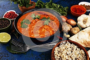 Chicken tikka masala spicy curry meat food in pot with rice and naan bread. indian food