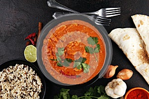 Chicken tikka masala spicy curry meat food in pot with rice and naan bread. indian food