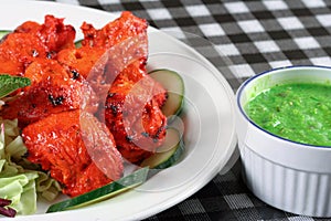 Chicken tikka with salad and sauce