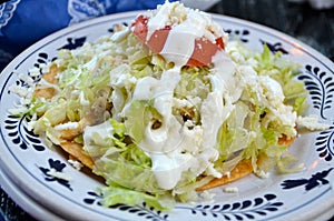 Chicken tostada with sour cream photo