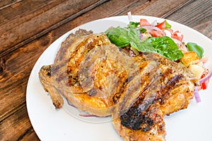 Chicken under a brick with panzanella salad photo