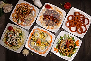 chicken vegetable cashew nut salad, classic Greece salad, russian salad, grilled chicken salad, munchies and fried onion rings photo