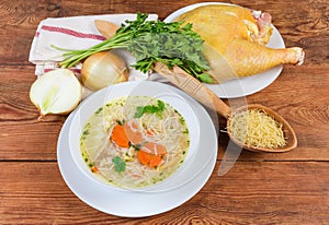 Chicken vermicelli soup in bowl among the some raw ingredients