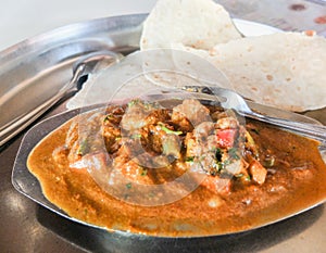 Chicken vindaloo with 2 chapatis,on a steel plate in Goa,India
