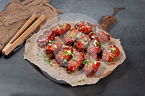 Chicken Winglets 12 piece isolated on wooden board on grey background side view of fastfood