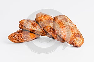 Chicken wings fried until half cooked, semi-finished product with fresh herbs on a white background. Fast food. Quick