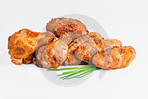 Chicken wings fried until half cooked, semi-finished product with fresh herbs on a white background. Fast food. Quick