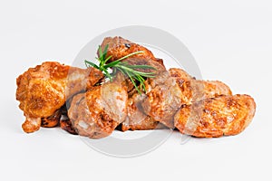 Chicken wings fried until half cooked, semi-finished product with fresh herbs on a white background. Fast food. Quick