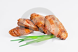 Chicken wings fried until half cooked, semi-finished product with fresh herbs on a white background. Fast food. Quick