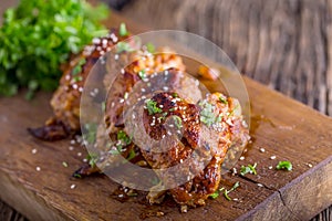 Chicken wings grilled BBQ parsley herb and sesame on wooden board