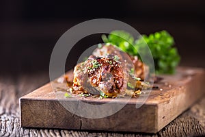 Chicken wings grilled BBQ parsley herb and sesame on wooden board