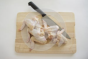 Chicken wings with huge knife for meat