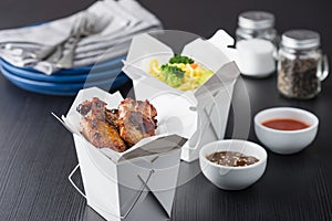 Chicken wings and noodles in take away noodles box