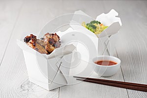 Chicken wings and noodles in take away noodles box