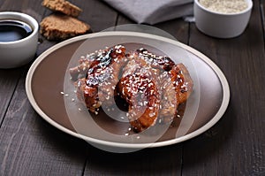 Chicken wings in and sauce with sesame seeds