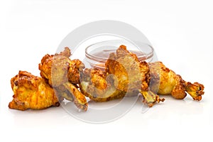 Chicken wings served with bbq sauce in glass bowl, isolated on white background. BBQ chicken meat pieces