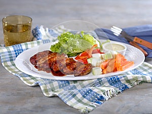 Chicken wings and vegetables with dip on platter