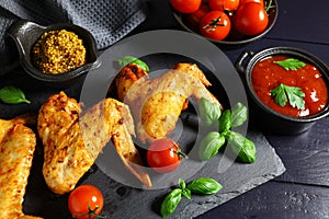 Chicken wings with vegetables and herbs. plate of grilled chicken wings