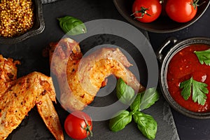 Chicken wings with vegetables and herbs. plate of grilled chicken wings